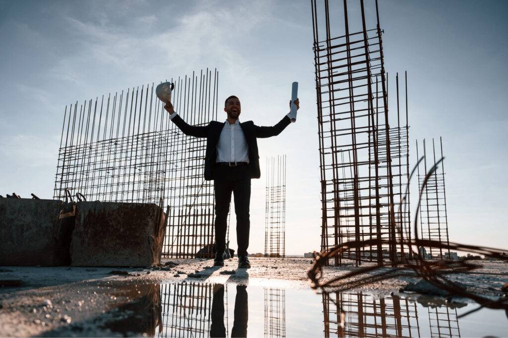 with-hands-up-standing-evening-time-businessman-formal-clothes-is-construction-site